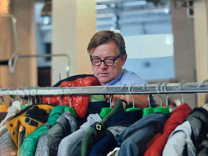 John looking at clothing on a rail